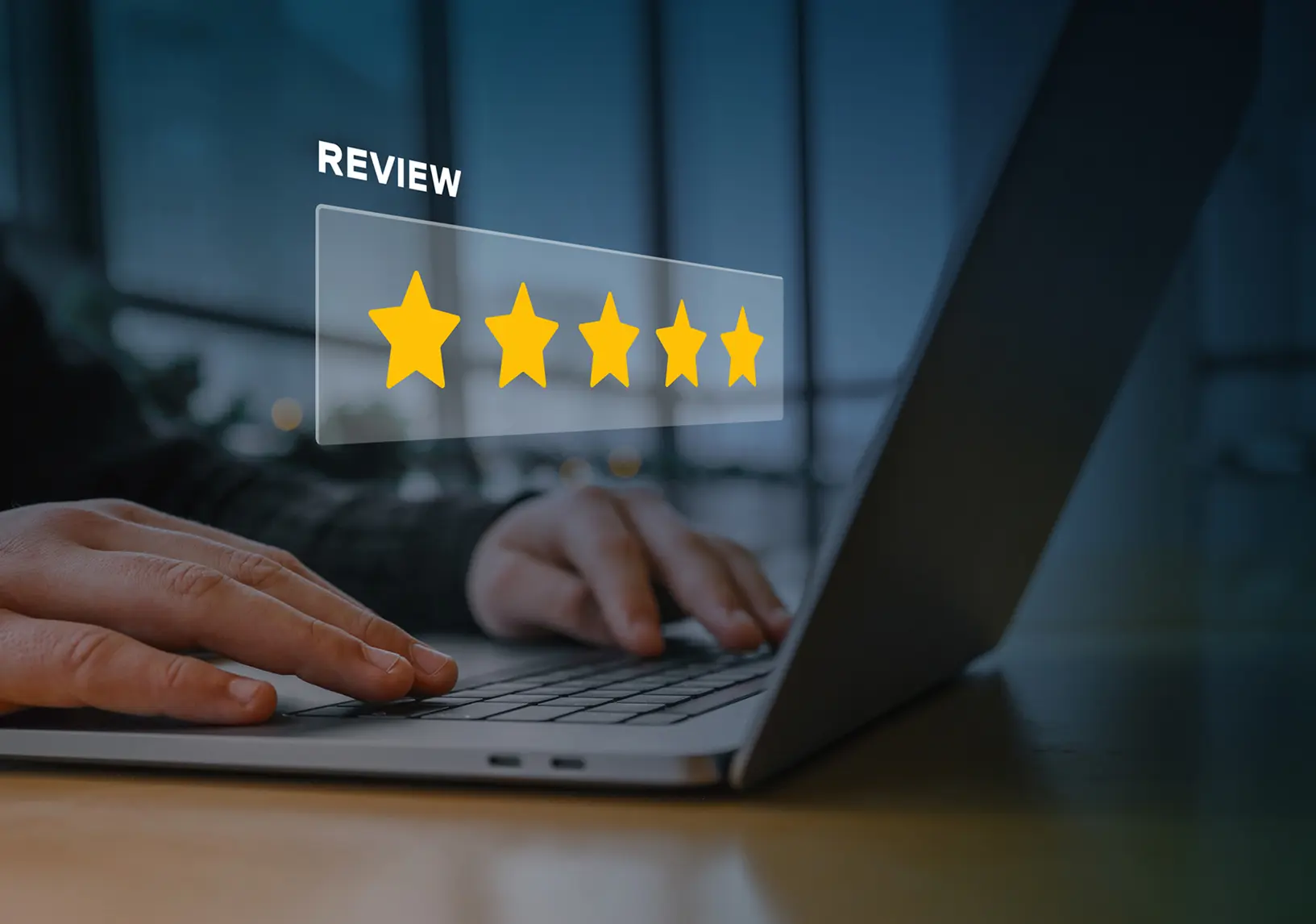 Hands typing on laptop, five-star review.