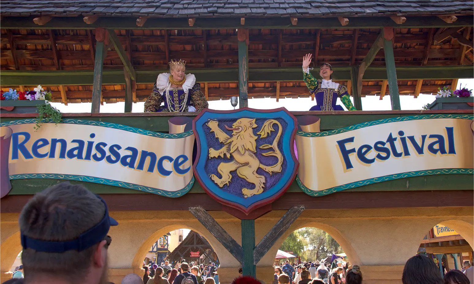 Renaissance festival entrance with costumed performers.